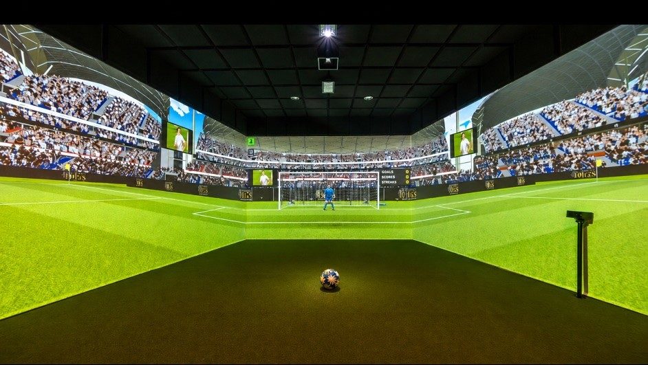 Soccer simulator room with a stadium projected across the screens