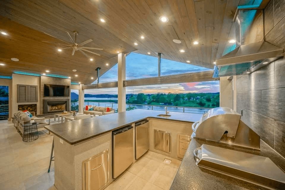 Outdoor kitchen and living space with lake views, lighting and audio